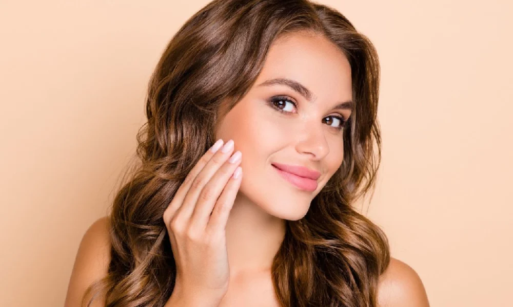 Smiling woman with glowing skin after Procell microneedling in Fall River, MA, showing smooth texture and youthful radiance.