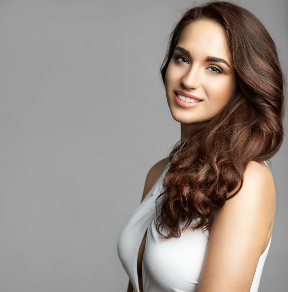 woman with a long thick curly hair and Voluma treatments from Aspirabody in Fall River, MA